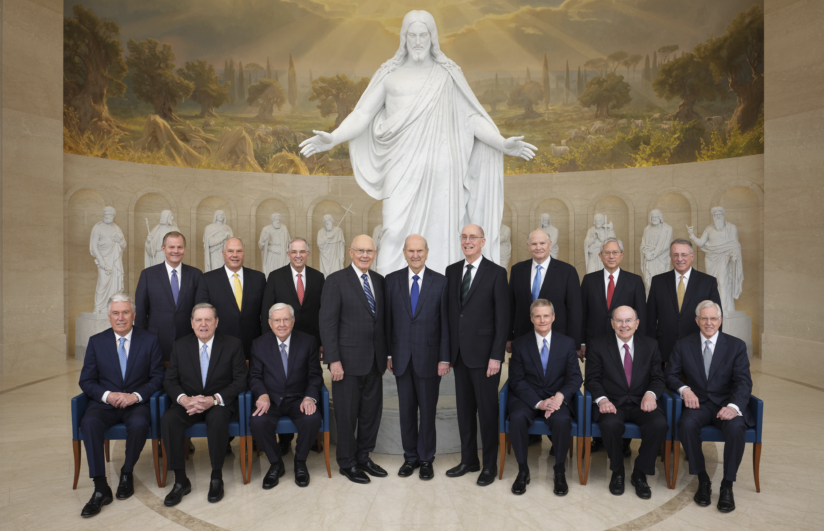 All the members of the First Presidency and the Quorum of the Twelve Apostles are seated or standing with the Christus Statue and statues of the Original Twelve at the Visitors' Center in Rome, Italy.  Front Left to Right: Dieter F. Uchtdorf, Jeffrey R. Holland, M. Russell Ballard, Dallin H. Oaks, Russell M. Nelson, Henry B. Eyring, David A. Bednar, Quentin L. Cook, D. Todd Christofferson, Gary E. Stevenson, Ronald A. Rasband, Neil L. Andersen, Dale G. Renlund, Gerrit W. Gong, Ulisses Soares