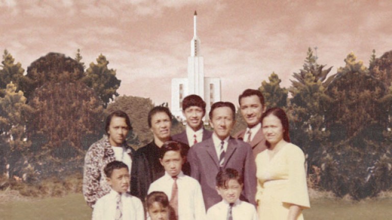 A vintage photograph of a family in front of a temple
