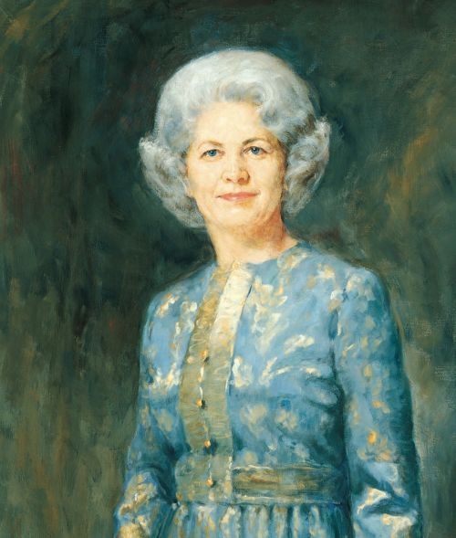 A painted portrait by Cloy Paulson Kent of Barbara Bradshaw Smith against a green and blue background, wearing a blue dress with buttons down the front.