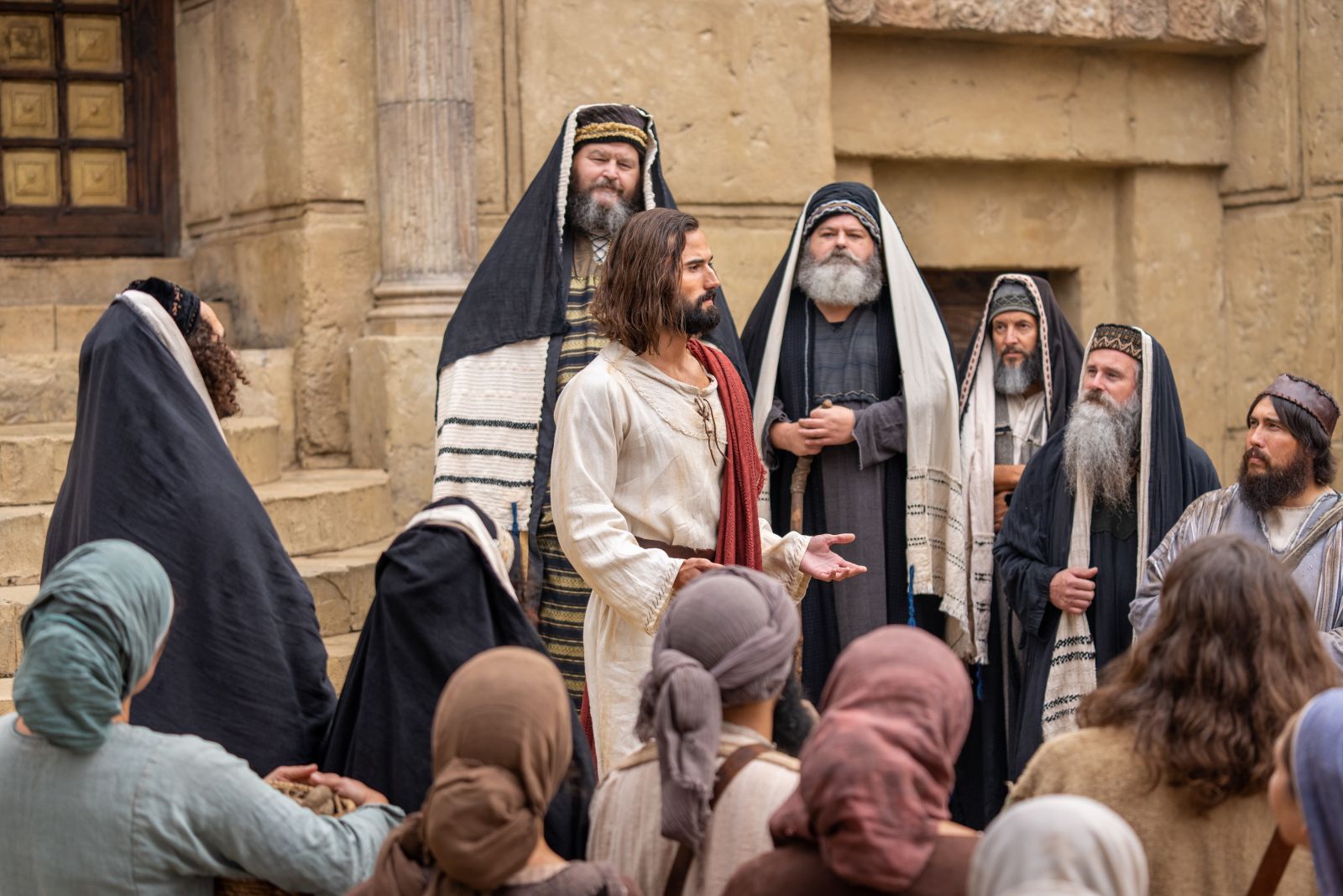 An image, taken from the Book of Mormon videos, of Christ teaching his apostles in Jerusalem in front of the Pharisees
