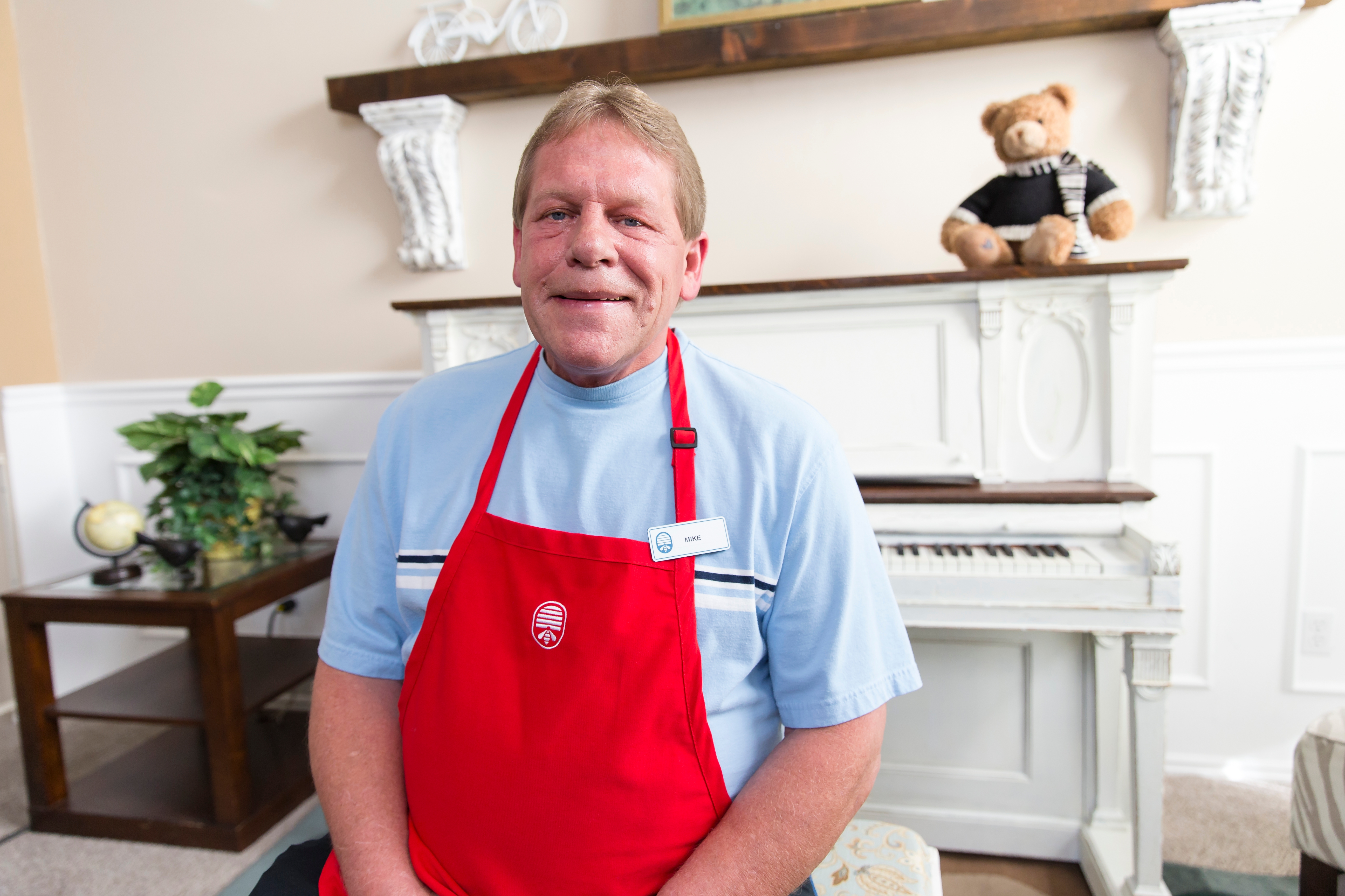 A Deseret Industries Employee smiles with the restored piano.
