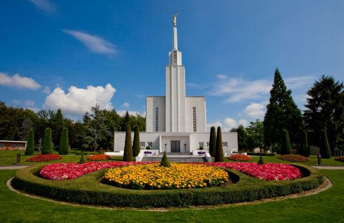 A large, well-kept flower bed with the Bern Switzerland Temple in the background.