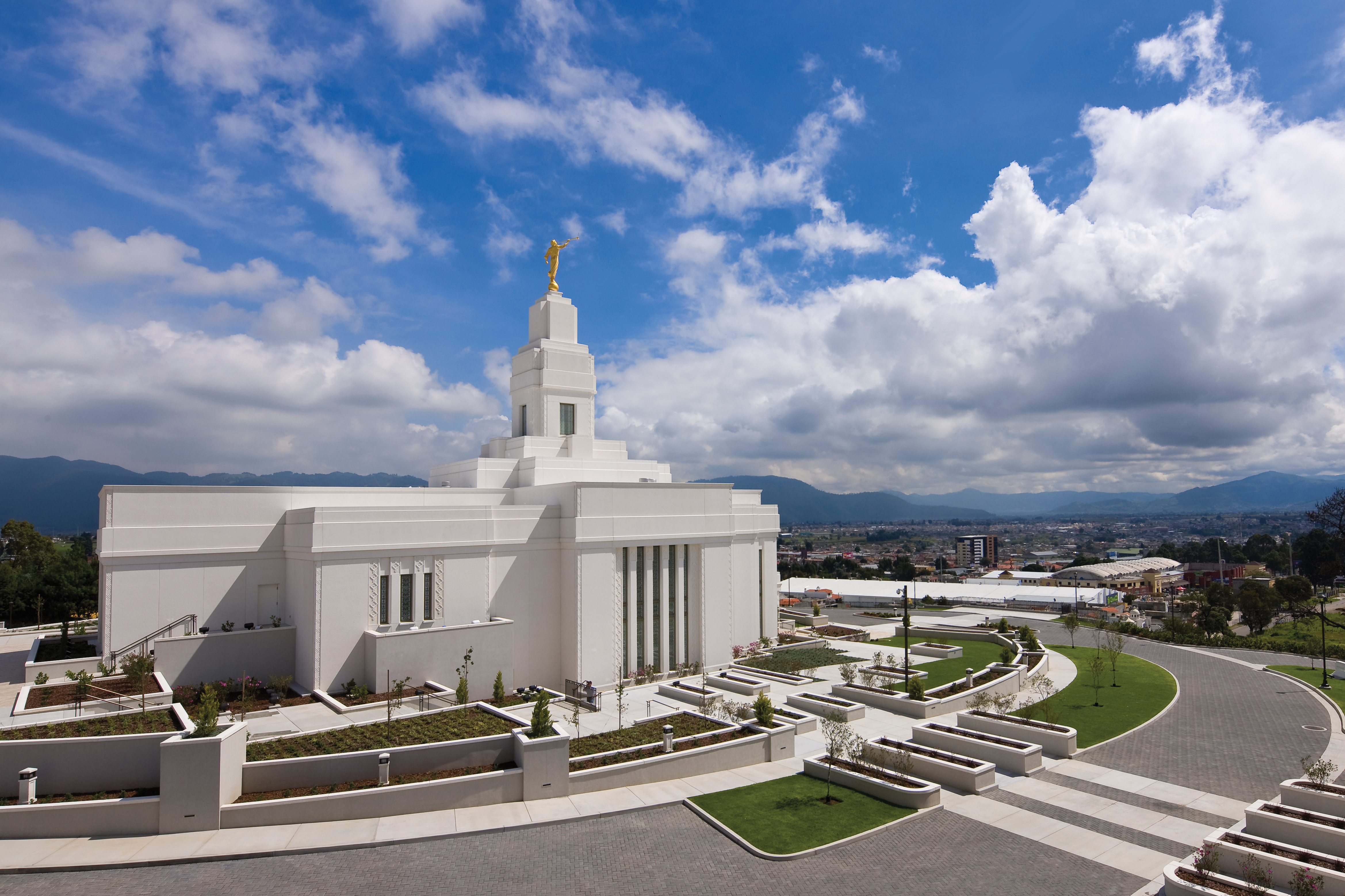 A view of the entire Quetzaltenango Guatemala Temple, including a view of the grounds and the city below.
