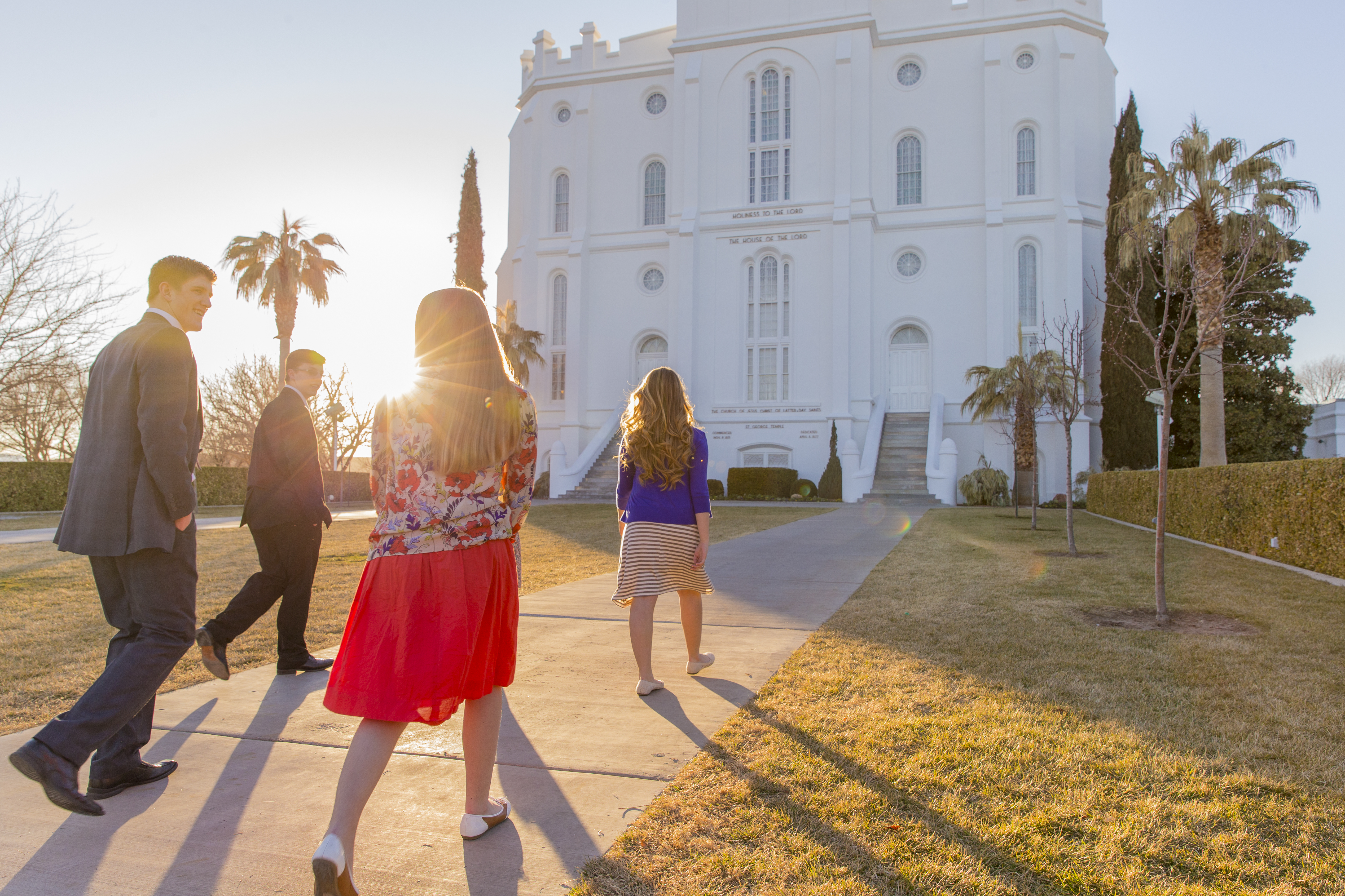 A group of youth walk toward the entrance of the St. George Utah Temple.  