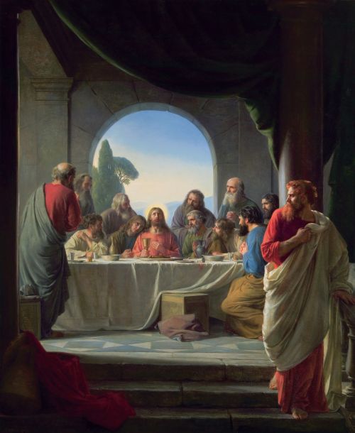 A painting by Carl Bloch showing Christ and 11 Apostles partaking of the Last Supper while Judas sneaks away in the foreground.