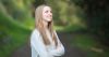 Smiling young woman looking upward