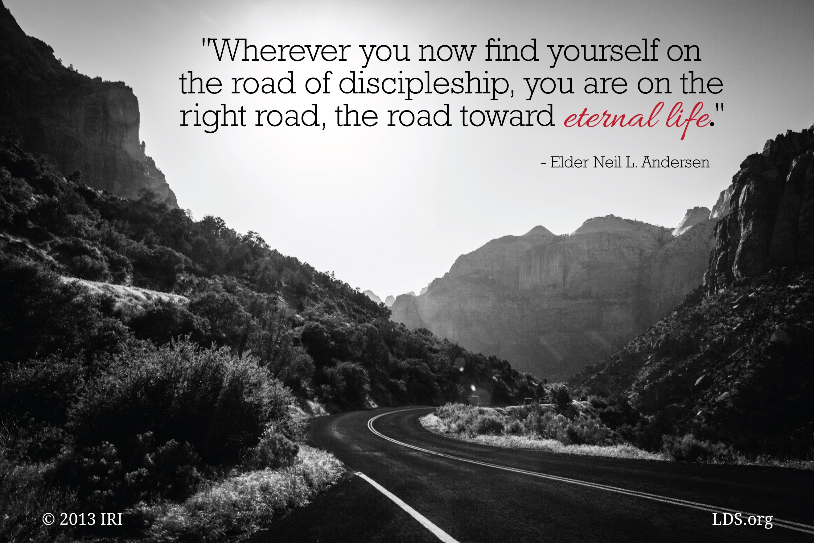 A black-and-white image of a road passing through mountains, with a quote by Elder Neil L. Andersen on top: “The road of discipleship.”
