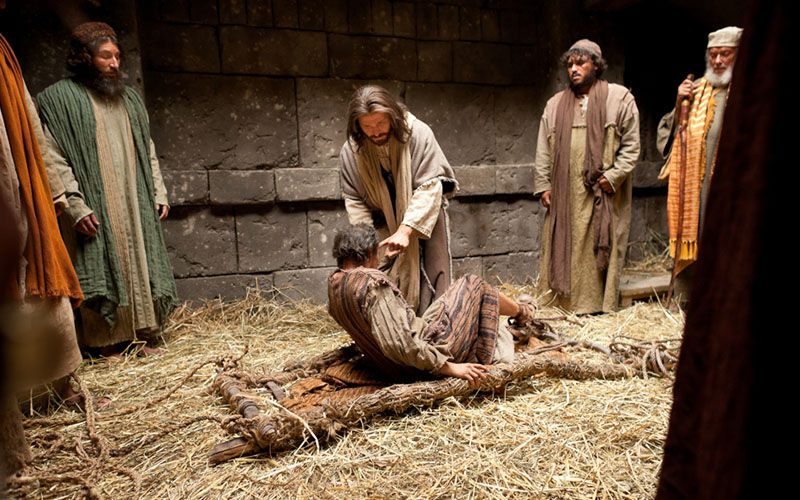 Jesus Christ forgives and heals a paralytic raising him from his bed