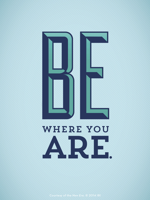 A solid light blue background with bold letters in different shades of blue: “Be where you are.”