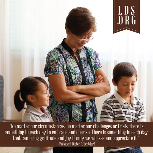 A photograph of a family prayer, paired with a quote by President Dieter F. Uchtdorf: “There is something in each day to embrace and cherish.”