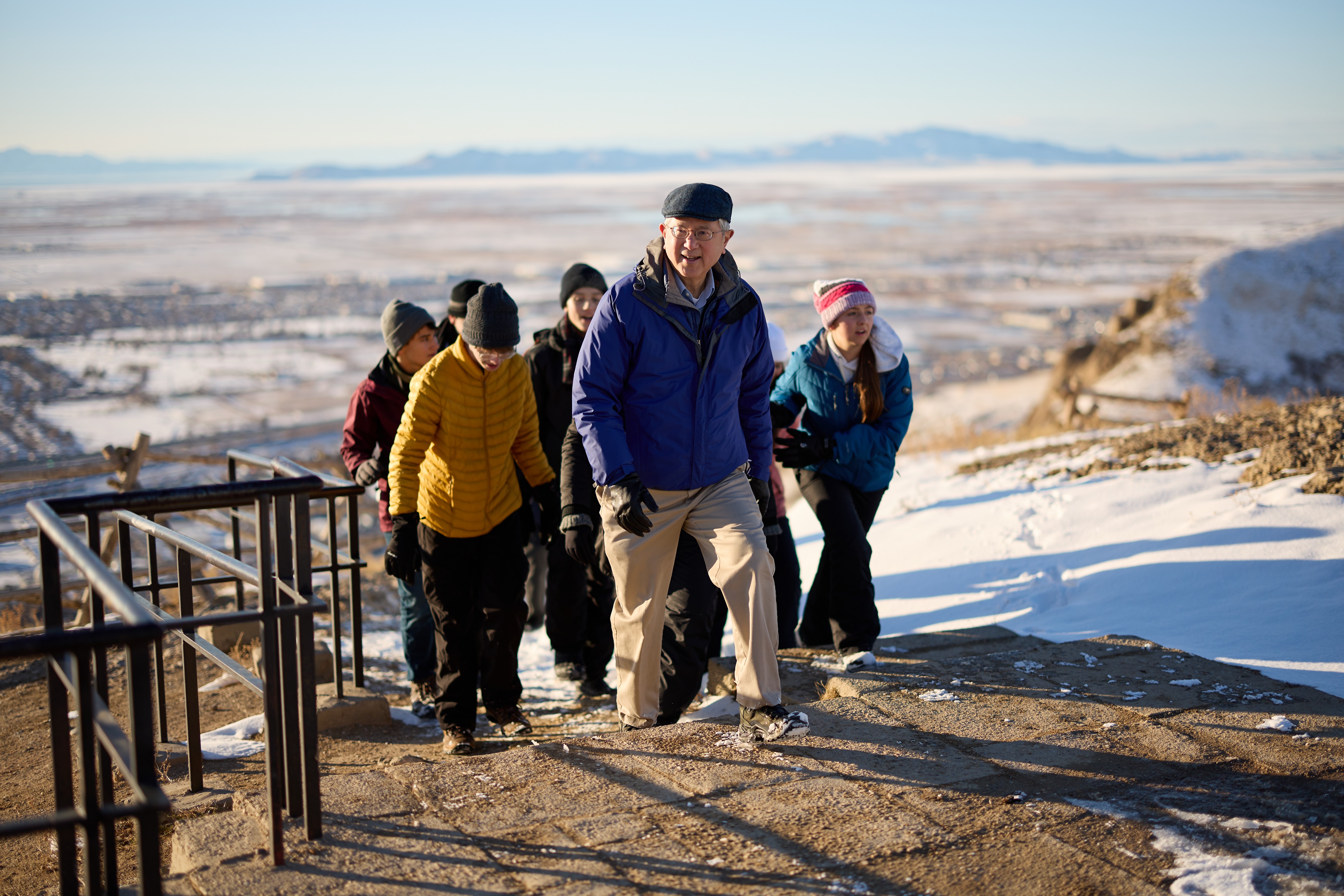 Elder Gerrit W. Gong hikes Ensign Peak with a group of youth. This is for a devotional happening in 2023. 