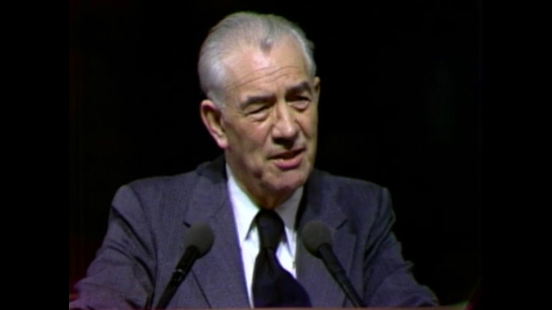 A photo of Mark E. Petersen standing at the pulpit in the General Conference Center.
