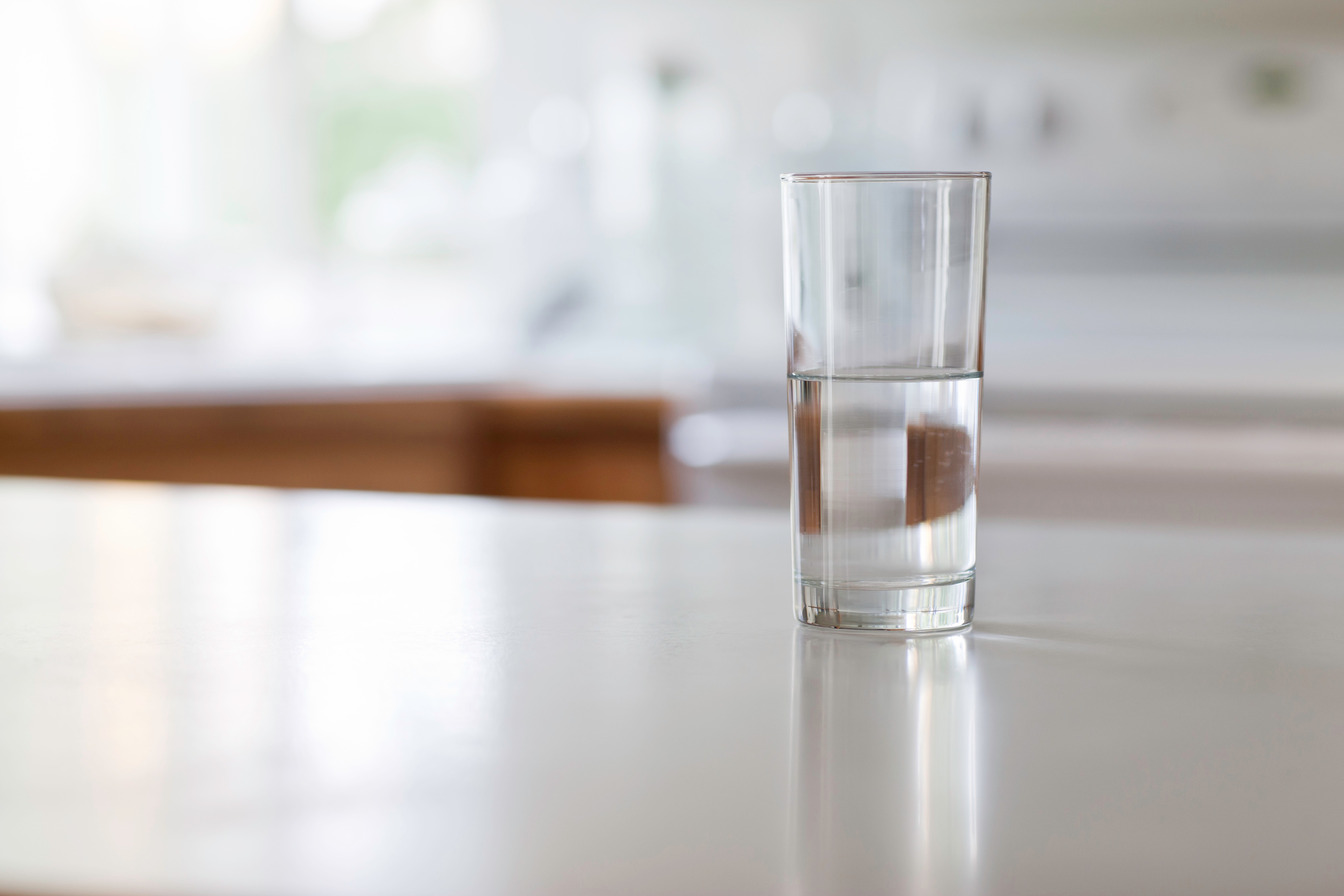 A glass of water on a table.  
