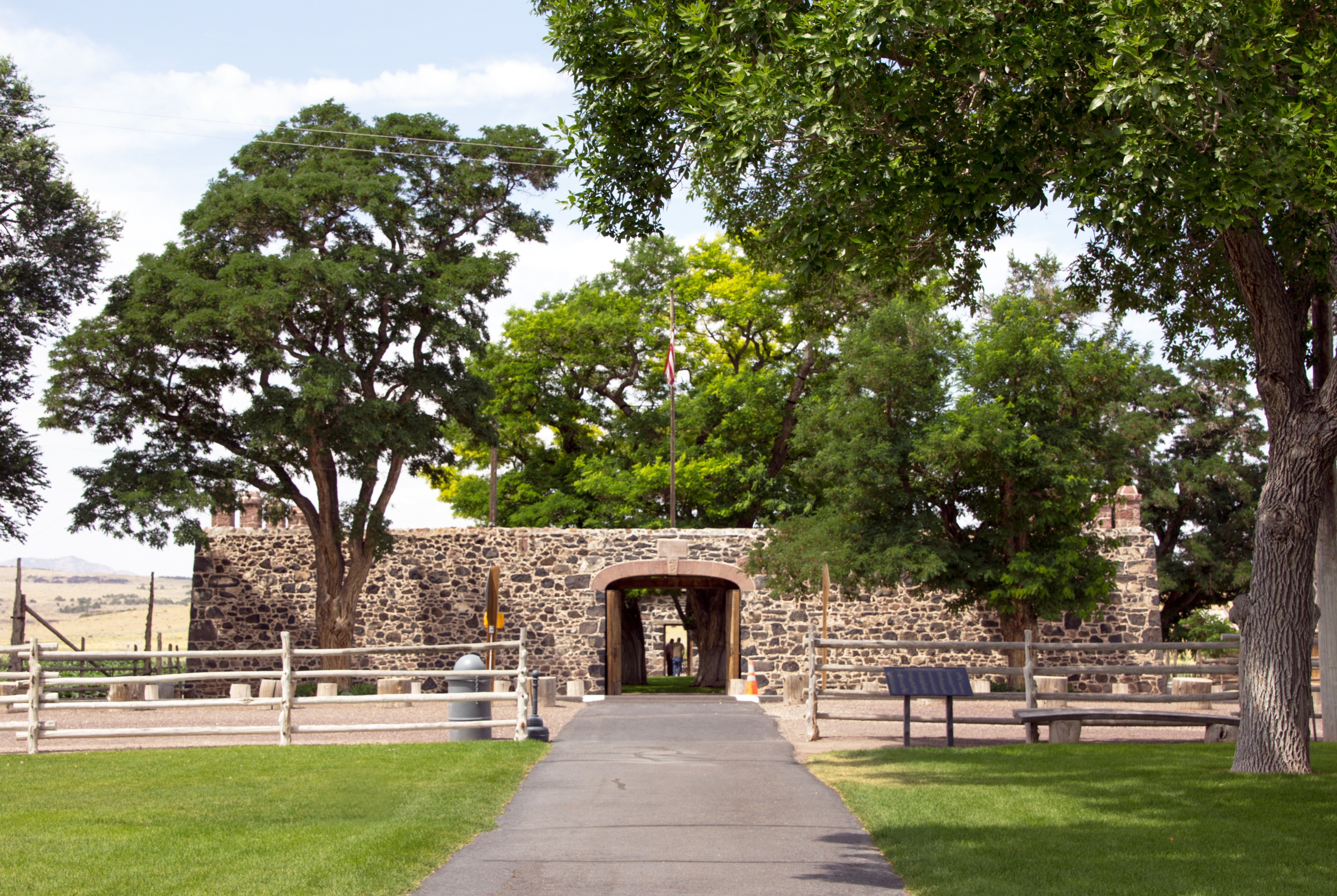 A stone wall with a large gate serving as the entrance to Cove Fort in Utah.