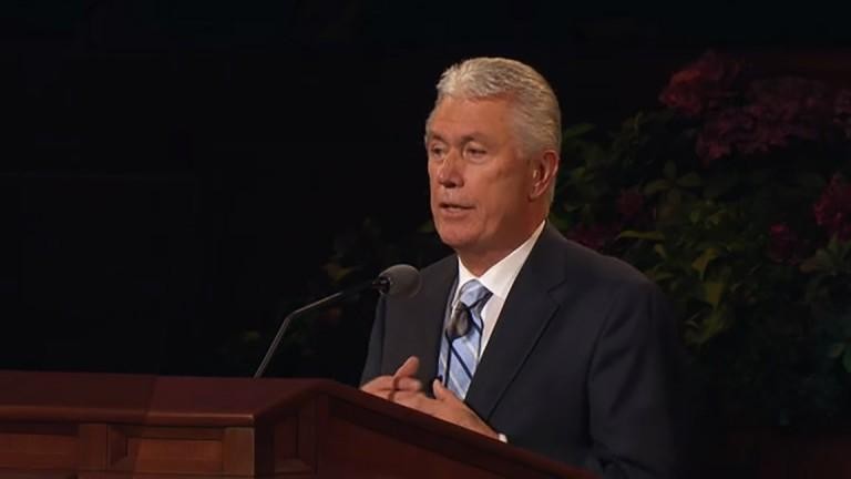 President Dieter F. Uchtdorf standing at the podium at General Conference.