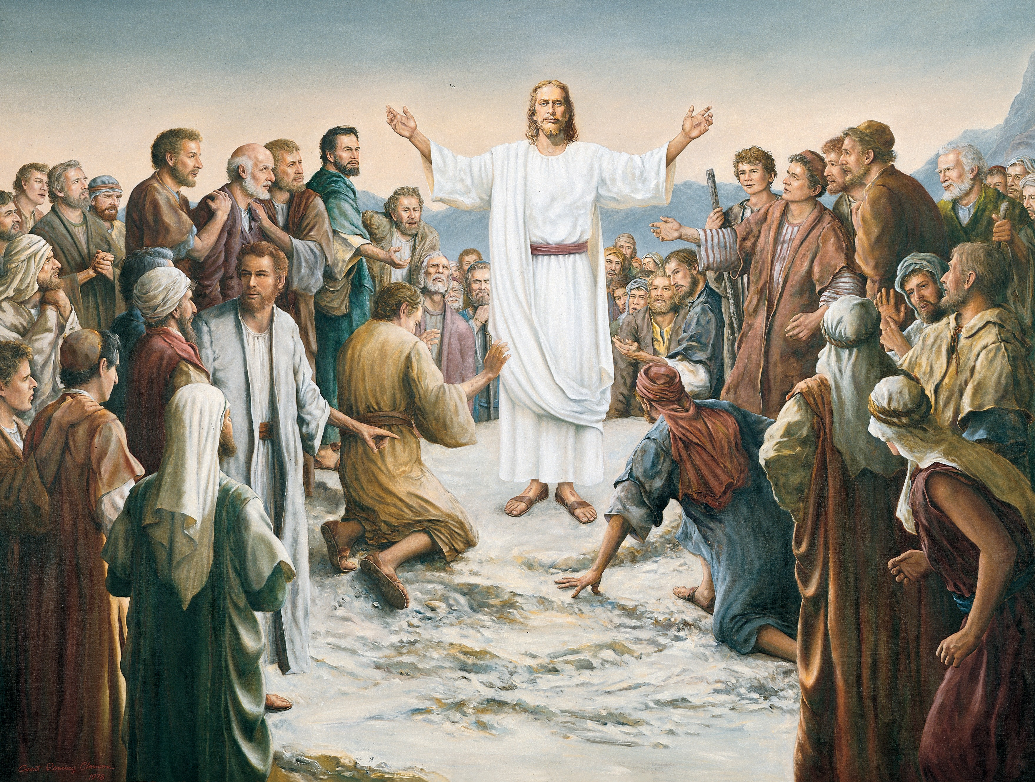Jesus Christ in white robes and a red sash stands in the midst of a large group with His wounded hands outstretched.