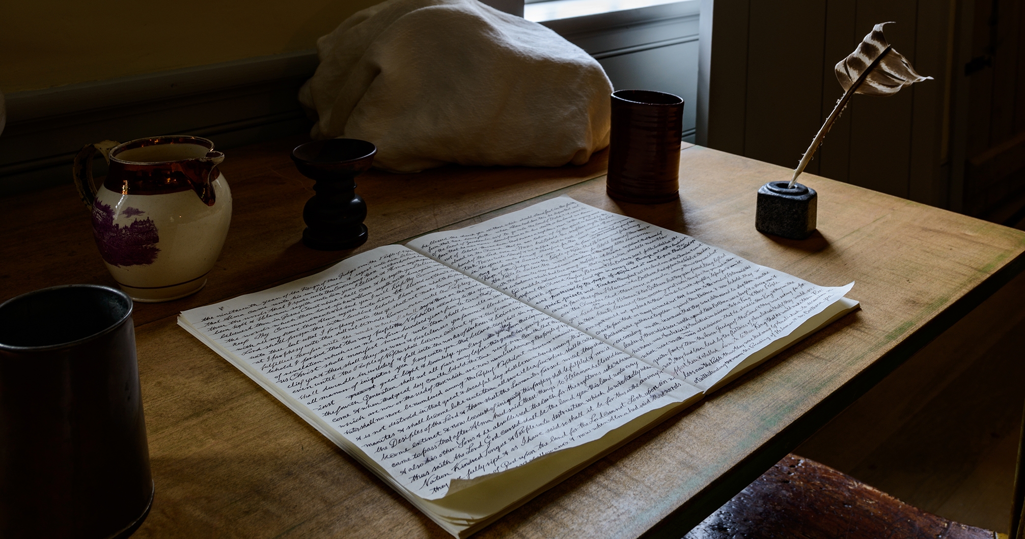 Book of Mormon manuscript lies open on table in the Hale home at the Priesthood Restoration Site in Pennsylvania.