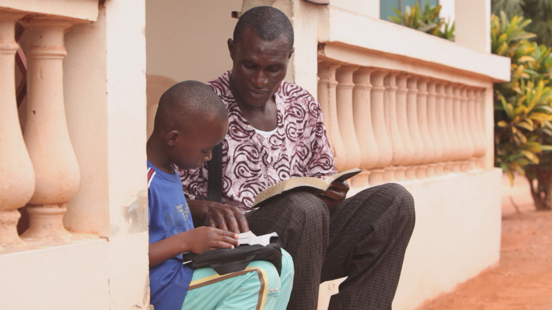 A parent and child read scriptures together