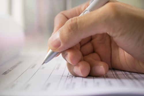person signing a form