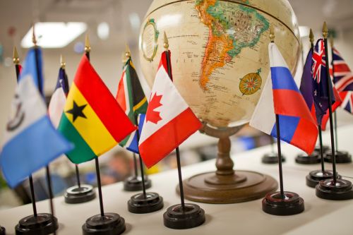 Flags by a globe.