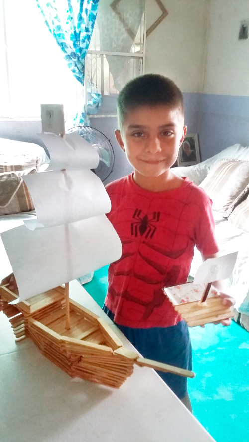 Young boy and his homemade boat