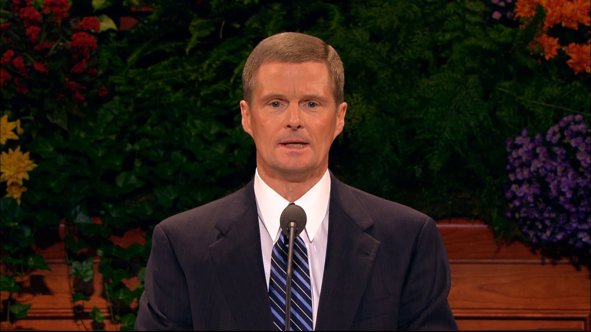 A photo of Elder David A. Bednar standing at the pulpit in the General Conference Center.