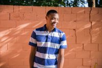 A man stands in his yard smiling enjoying the blessings of the gospel of Jesus Christ