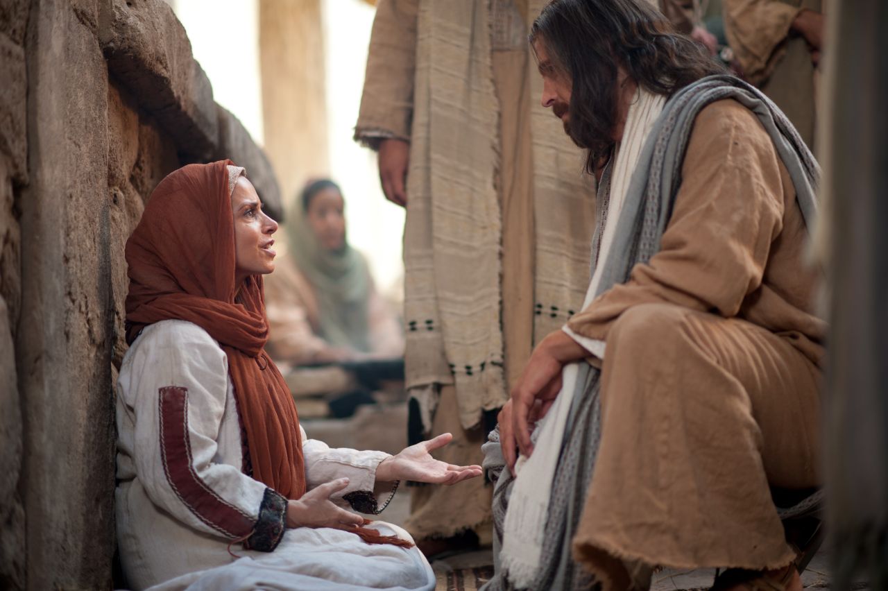 Jesus Christ speaks with a woman who through faith touched his clothes and was healed