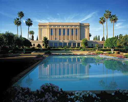 A view of the Mesa Arizona Temple and its reflection in a large pool on the grounds.