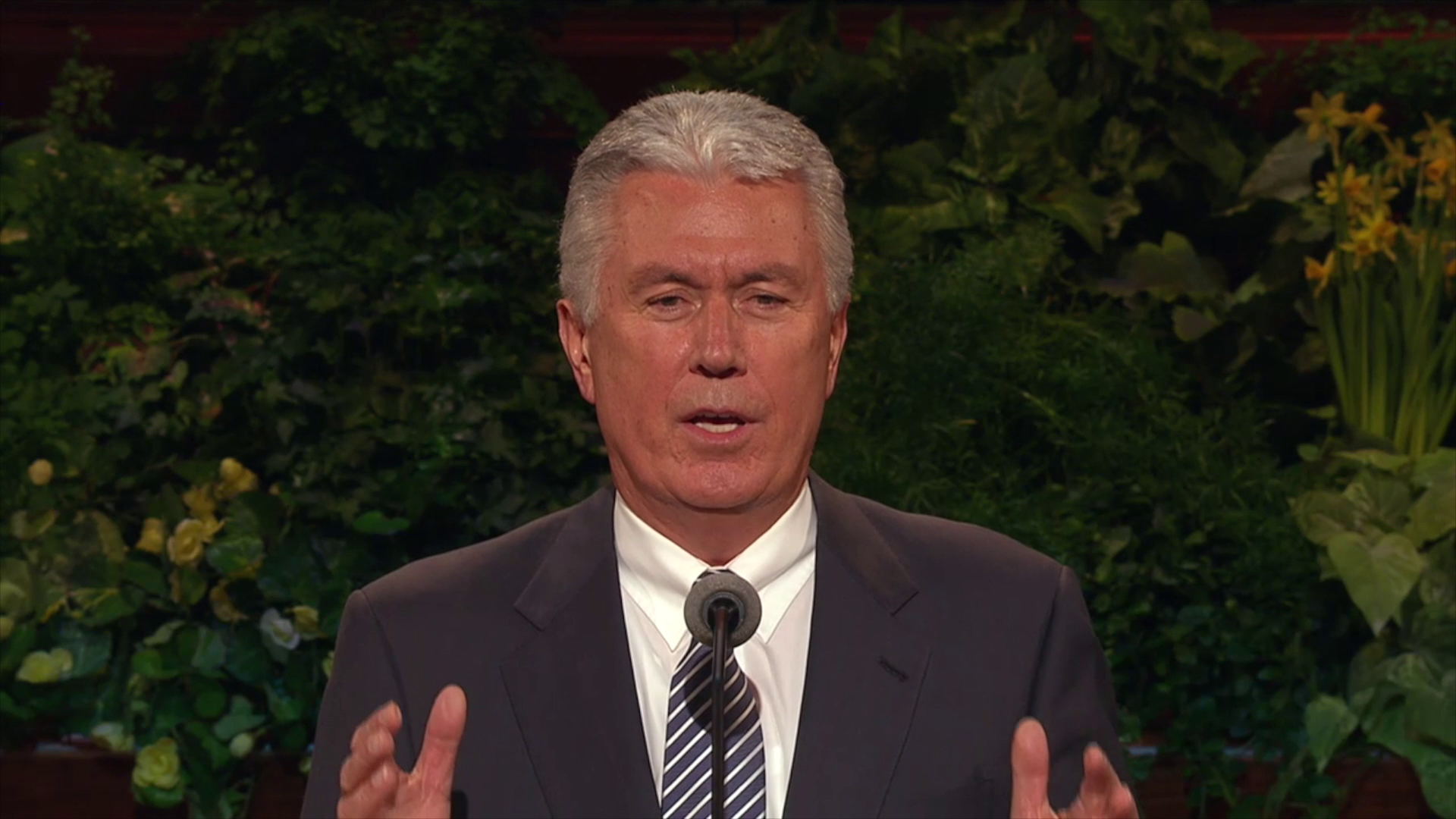 A photo of President Dieter F. Uchtdorf standing at the pulpit in the General Conference Center.