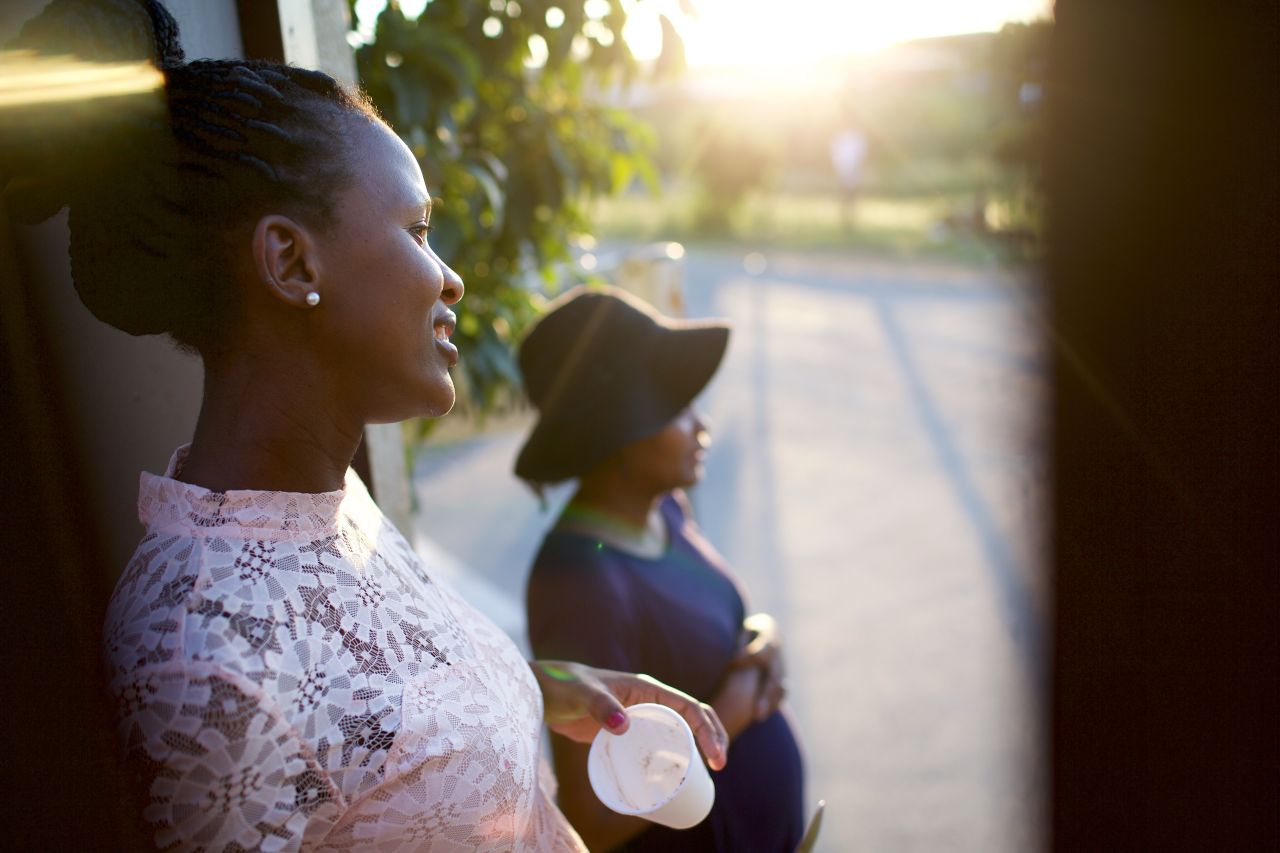 Two women look out of their front room