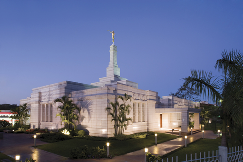 A view of the Asunción Paraguay Temple in the evening, with the temple and the grounds illuminated by the lights.