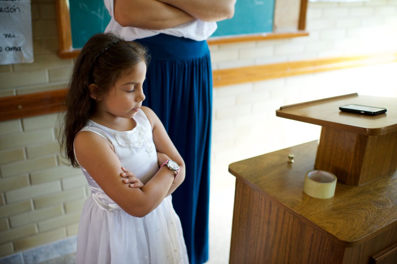 A small girl praying in Primary