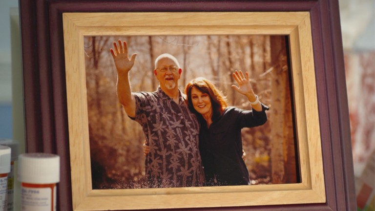 A photo of a picture frame with a photo of a couple in the frame.