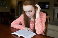 concerned-looking youth reading the Bible