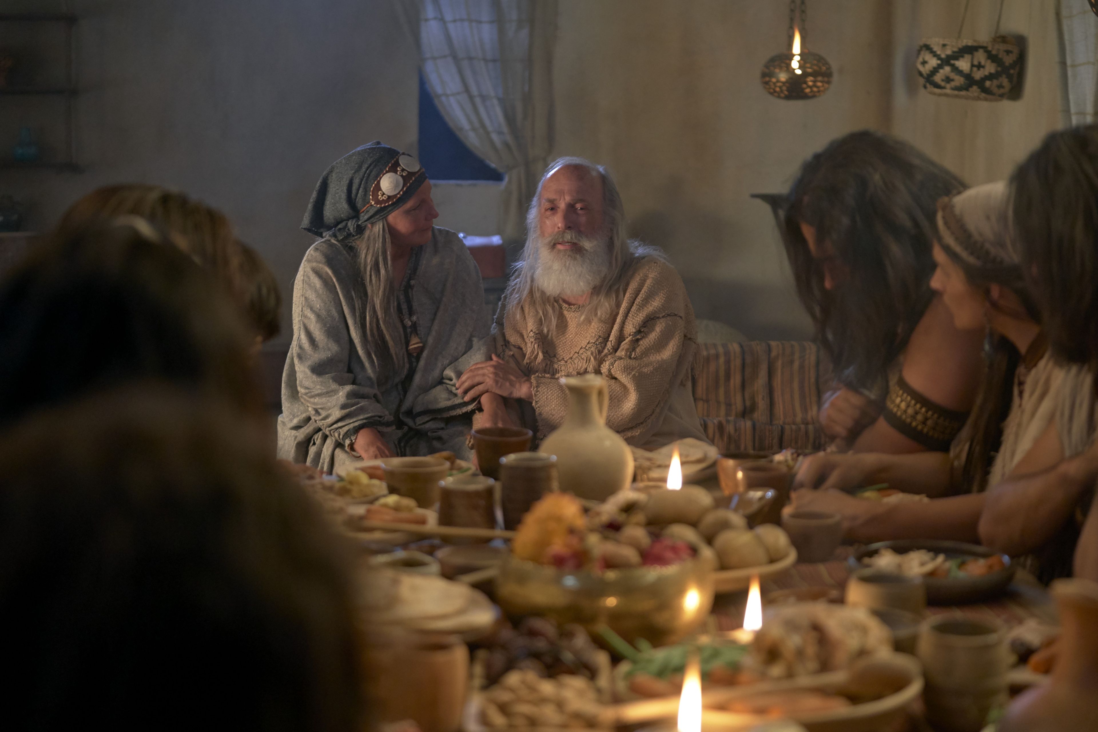 Lehi and Sariah teaching their family while dining