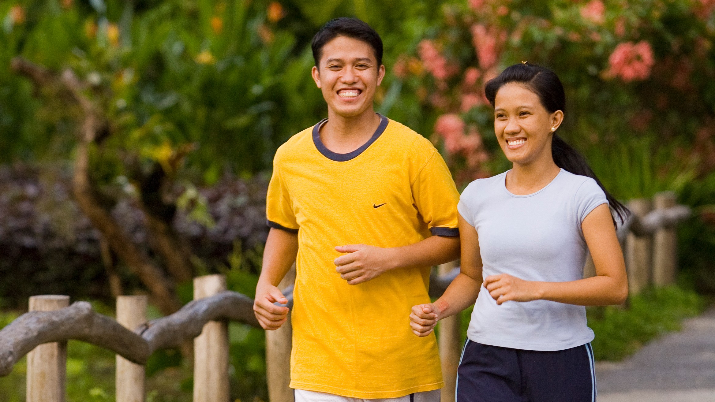 A young Filipino couple jogging together.