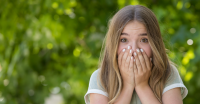 Girl covering her mouth