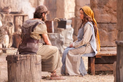 Mary sitting and talking with Joseph