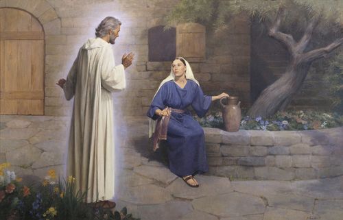 The angel Gabriel (Noah) appearing to Mary and declaring to her that she would become the mother of Jesus Christ. Mary is depicted seated on a round stone ledge. The ledge borders a tree and flowers. The angel Gabriel is depicted wearing white robes. A stone wall and stairways are in the background. There are flowers in the foreground. Luke 1:26-38